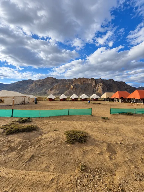 Mountain campsite with orange and cream tents